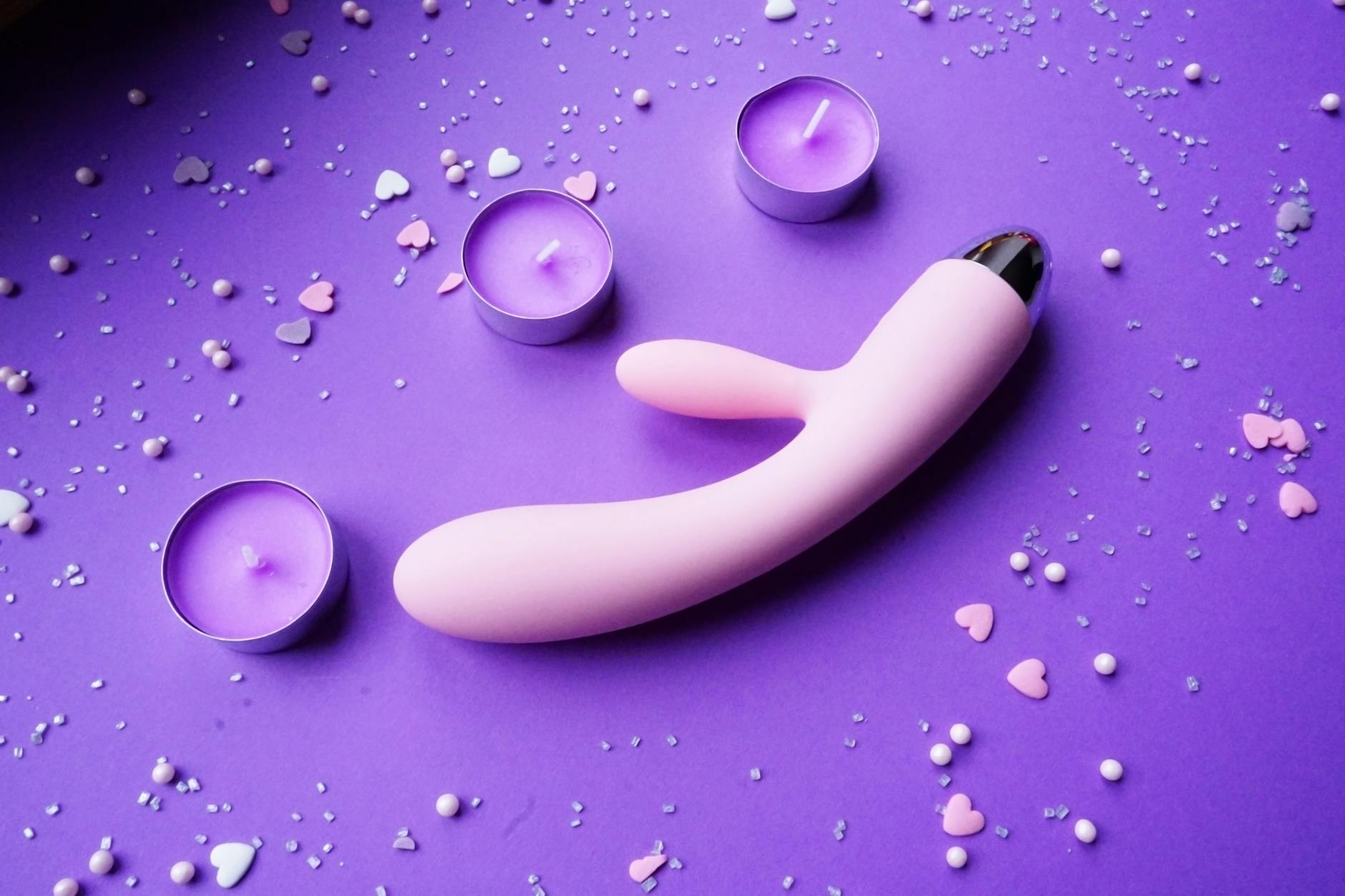 Vibrant display of various clitoral vibrators on a bright yellow surface